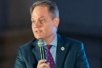 a man talking into a microphone