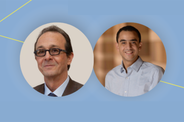Two men smiling with light blue background