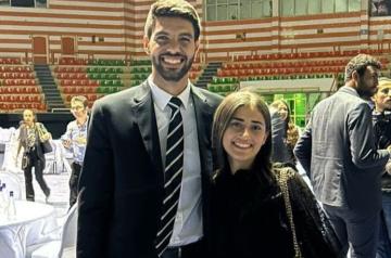 A male and female students standing and smiling