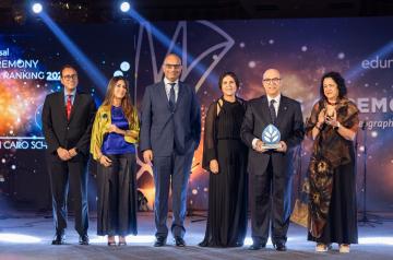 Group photo of people and a man holding an award