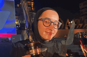 Female student holding an a award