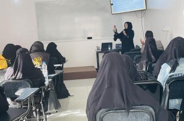 Back view of a classroom of veiled women
