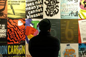 Man looking at colorful ads on a wall