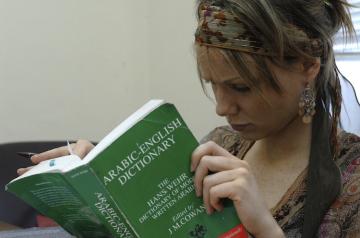 AUC student reading a book