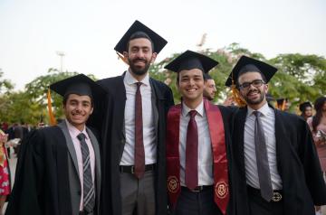A group of undergraduate men pose for a photo at commencements A group of undergraduate men pose for a photo at commencements