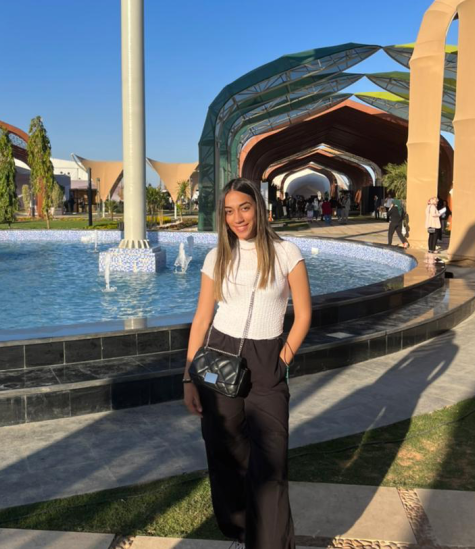 A girl standing in front of a fountain