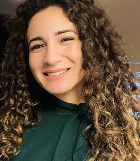 A girl with curly hair smiling