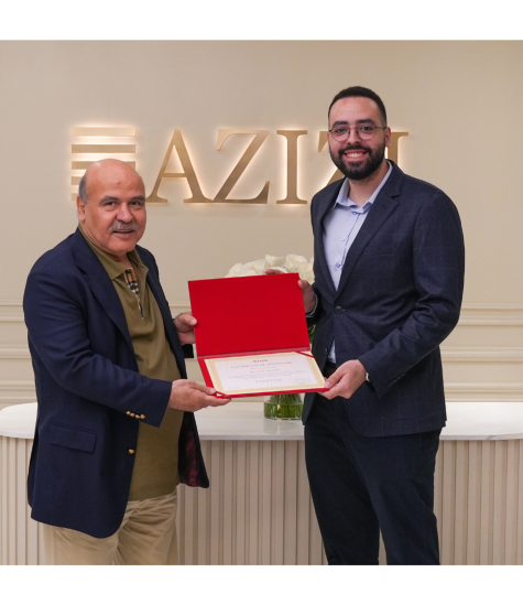 Hany Ibrahim receives his certificate from executive at Azizi Developments