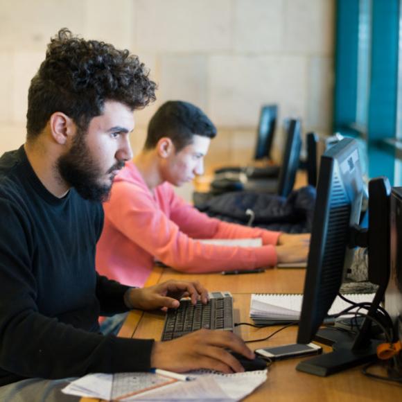 AUC students on the computers in the library 