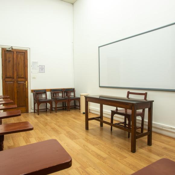 Chairs, tables and a board in a classroom