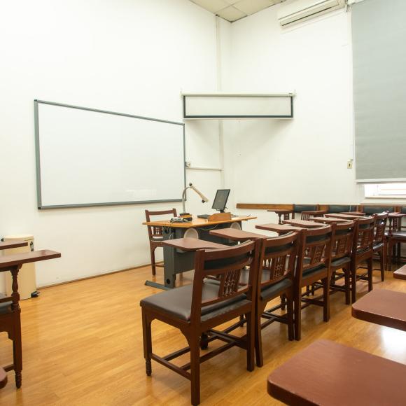 Chairs, tables and a board in a classroom