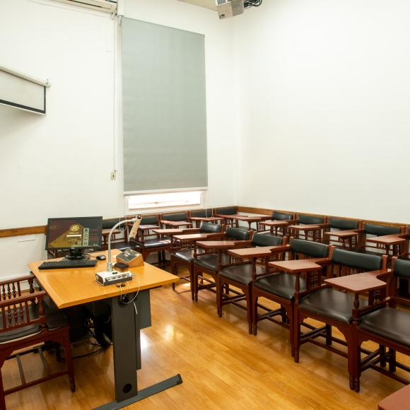 Chairs, tables and a board in a classroom