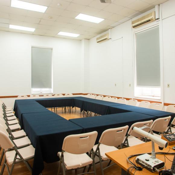 Large table, seats, a board and a computer