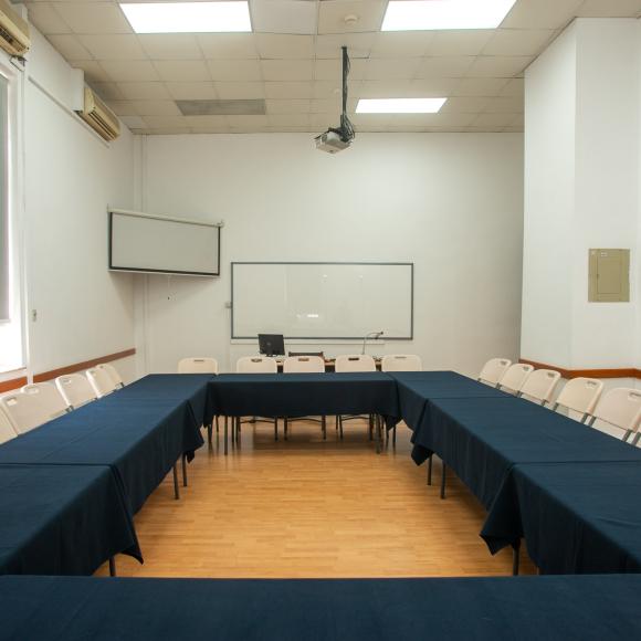 Large table, seats, a board and a computer