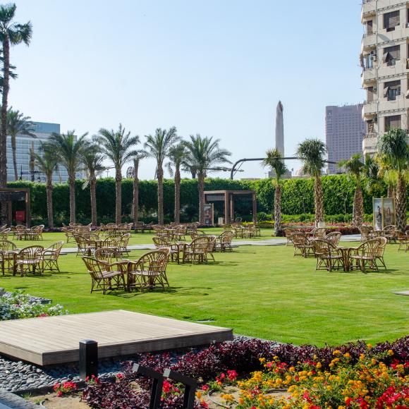 A garden with chairs and tables