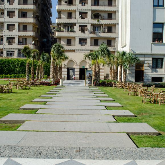 A garden with chairs, tables and a walk way