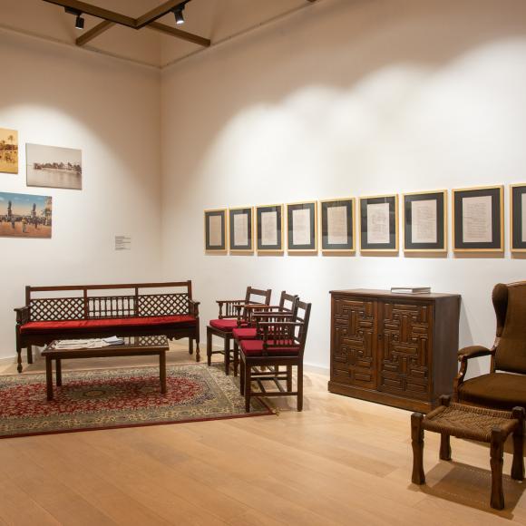 Seating area and paintings in a room