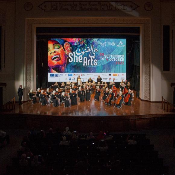 Group pf people on stage performing