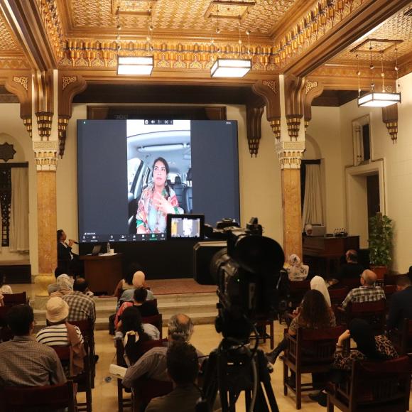 Group of people in a hall watching projector
