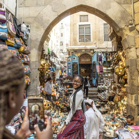 Girl posing to take a picture in the middle of old Cairo market
