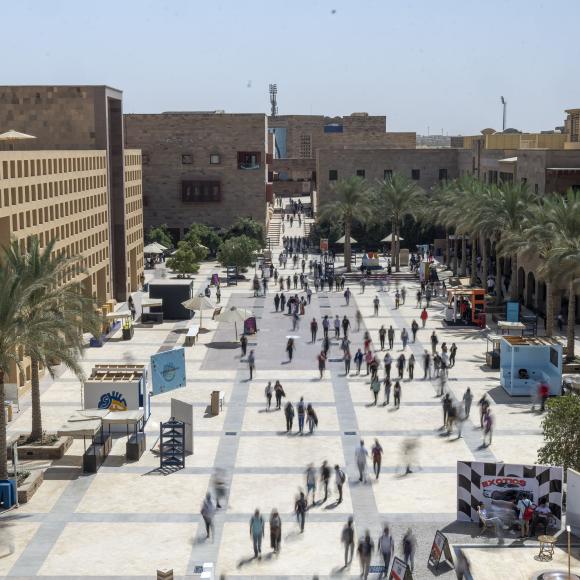 Top view of students going back and forth in AUC plaza