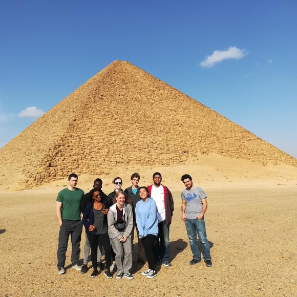 A group of girls and boys standing by the pyramids