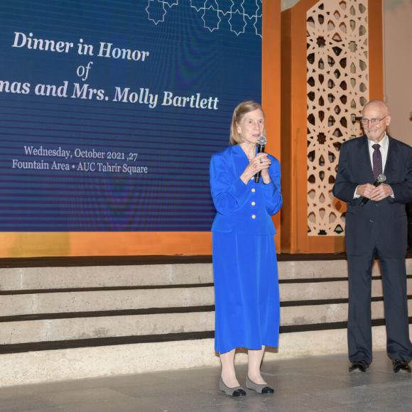 Molly speaking in an event and Thomas Bartlett beside her