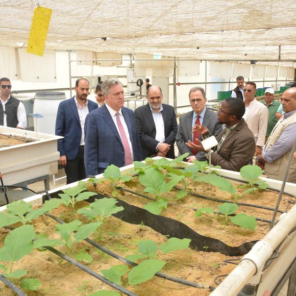 president ahmad dallal standing with a group of guests