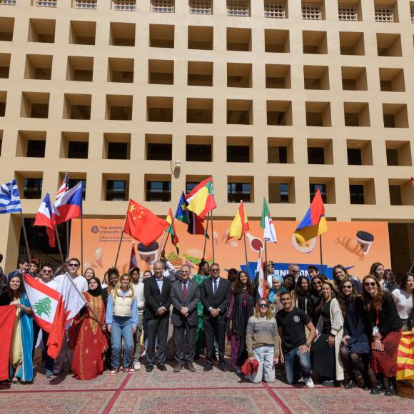 group photo of auc students in front of the library
