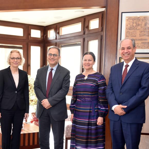 president ahmad dallal standing with a group of guests