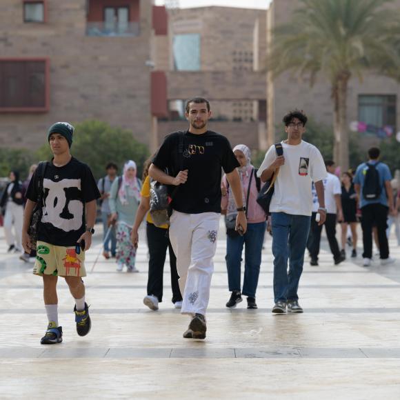 A group of boys walking on campus