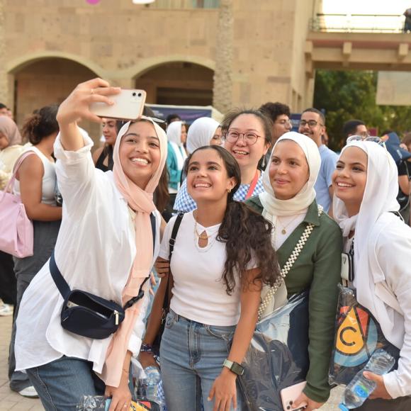Five female students taking a selfie in the Plaza