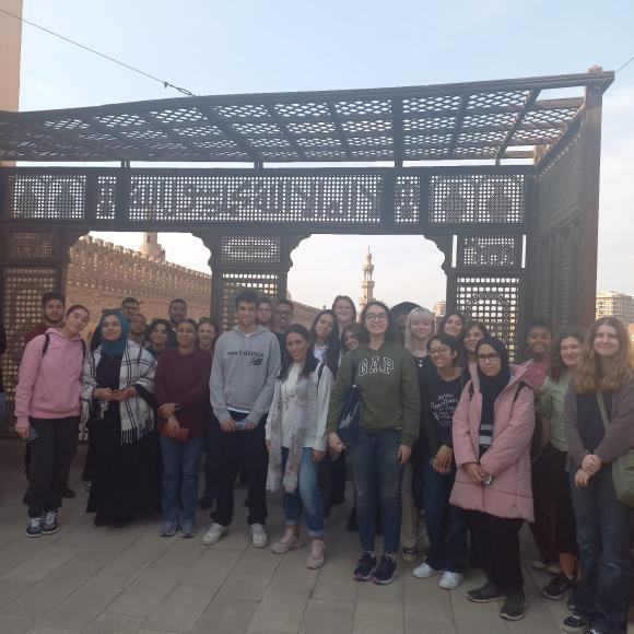 Students pose in front of a historic site in Cairo