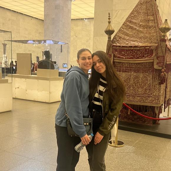 Two students pose in a museum