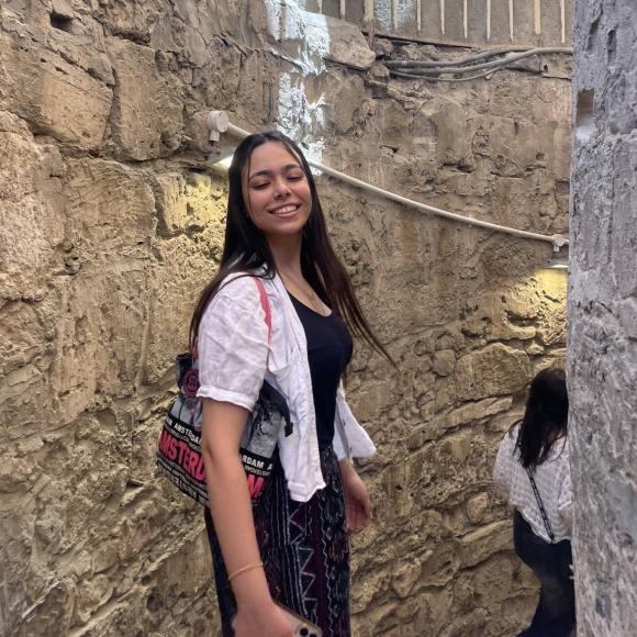 A student smiles on a staircase