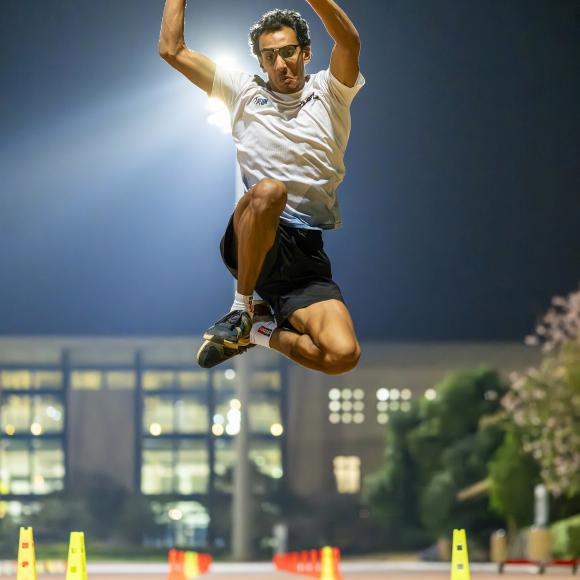 An athlete student jumping up high