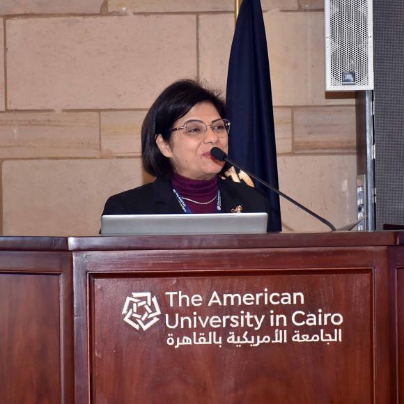 a lady with short black hair giving a speech