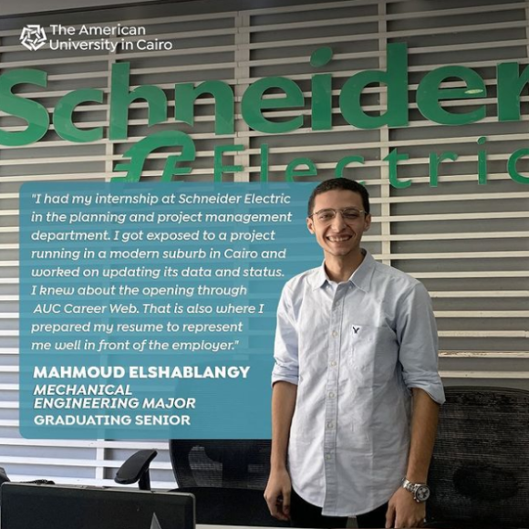 A male is standing in front of a wall that has the green "Schneider Electric" logo on it, text reads "Mahmoud Elshablangy, Mechanical Engineering major, Graduating Senior"