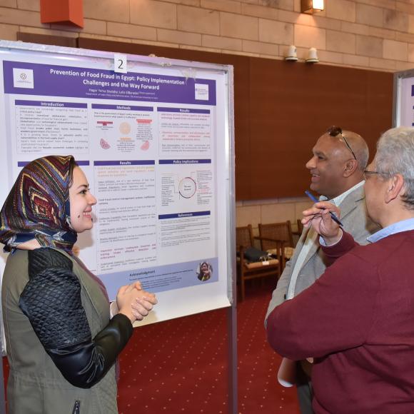 student presenting the poster to judges