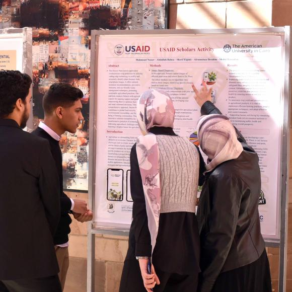 students presenting their poster