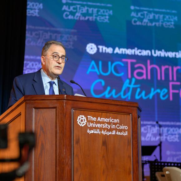 A man is standing at a podium. Text on screen: AUC Tahrir CultureFest 2024. The American University in Cairo