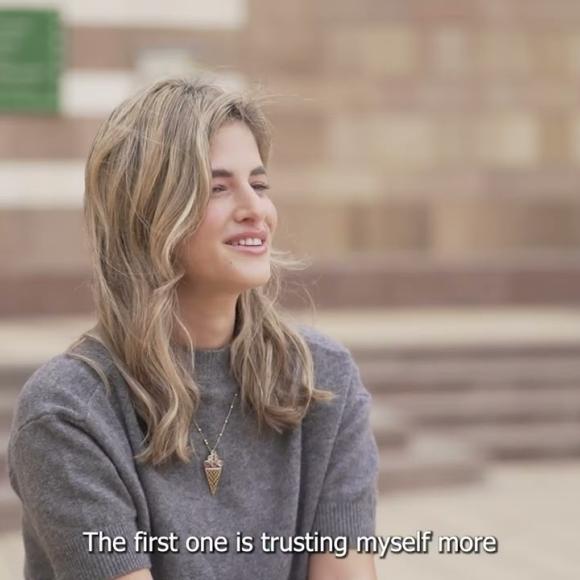 A female is talking and smiling