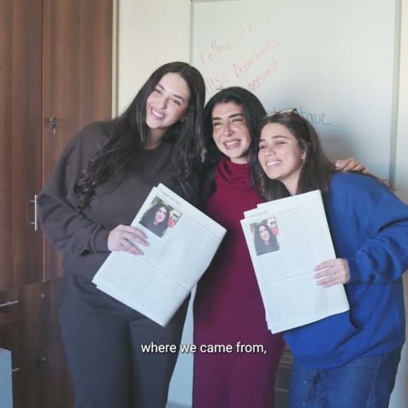 Three females standing together and smiling