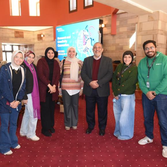 Males and females are standing together and smiling