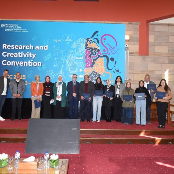 Males and females standing together and smiling. They are holding certificates. Text: Research and Creativity Convention 