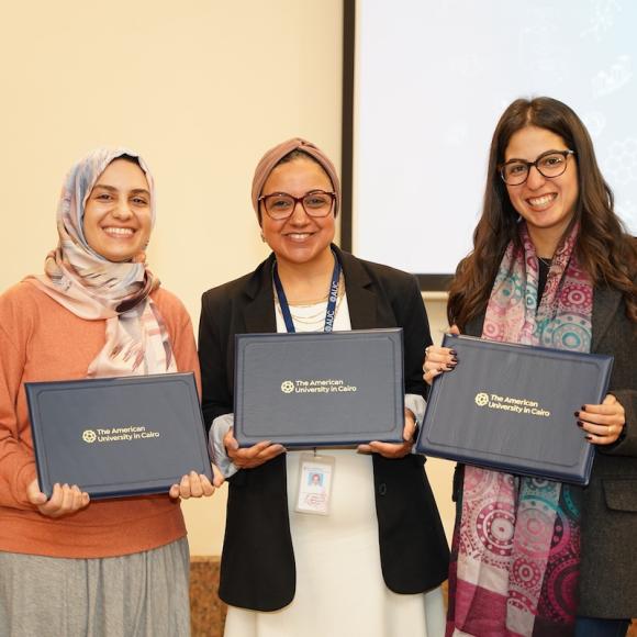 Three females holding certificates