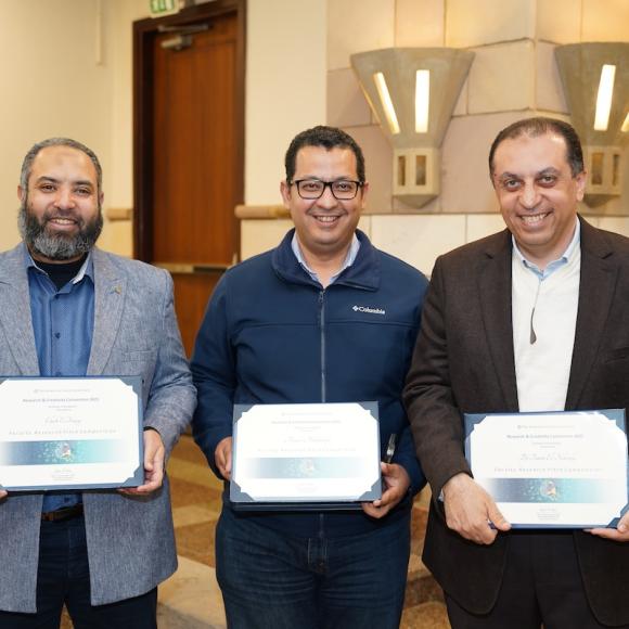 Three males holding certificates