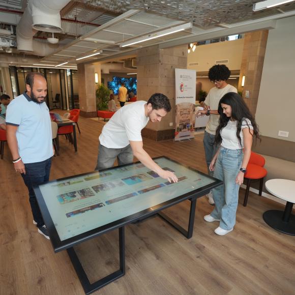 a group of students working on a screen at auc innovation hub work space