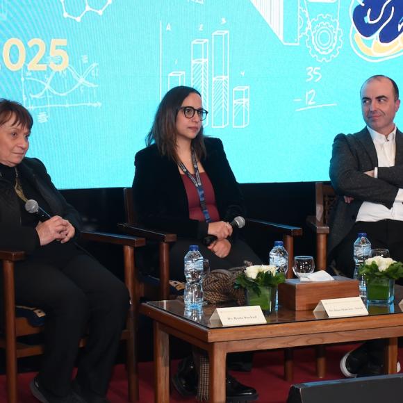 Three people sitting on the stage