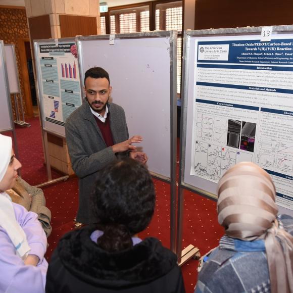 A male is explaining the contents on a board to three females